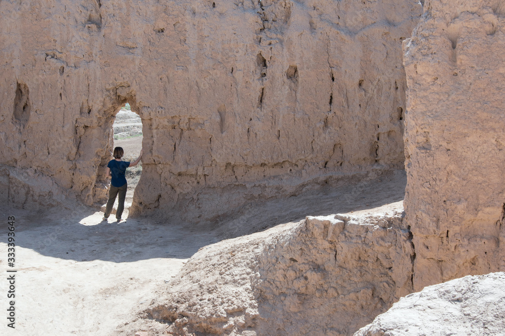 European she-tourist in Kyzyl Kala fortress, one of the most popular touristic destination in the country. Karakalpakstan, Uzbekistan, Central Asia. European she-tourist in Kyzyl Kala fortress, one of the most popular touristic destination in the country. Karakalpakstan, Uzbekistan, Central Asia.