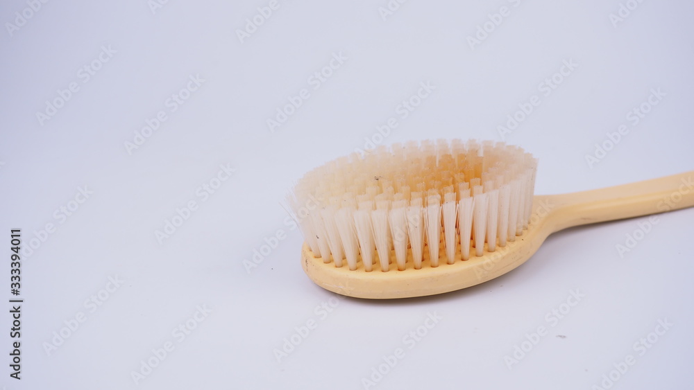 A dirty shower brush on a white background A dirty shower brush on a white background