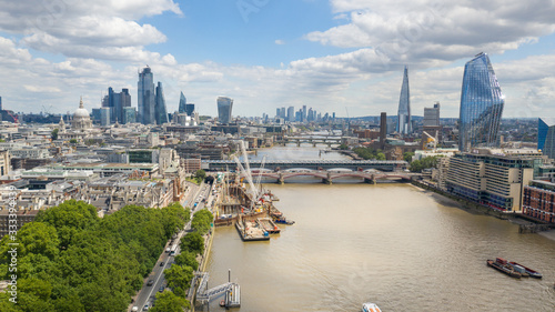 City of London, cityscape with modern buildings and skyscrapers skyline, Tower of London in foreground, clear blue sky - panorama of Great Britain from above, United Kingdom, Europe
