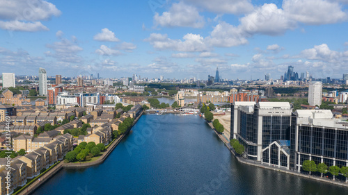 River Thames and water canal surrounded by residential buildings in London Docklands area near Canary Wharf
