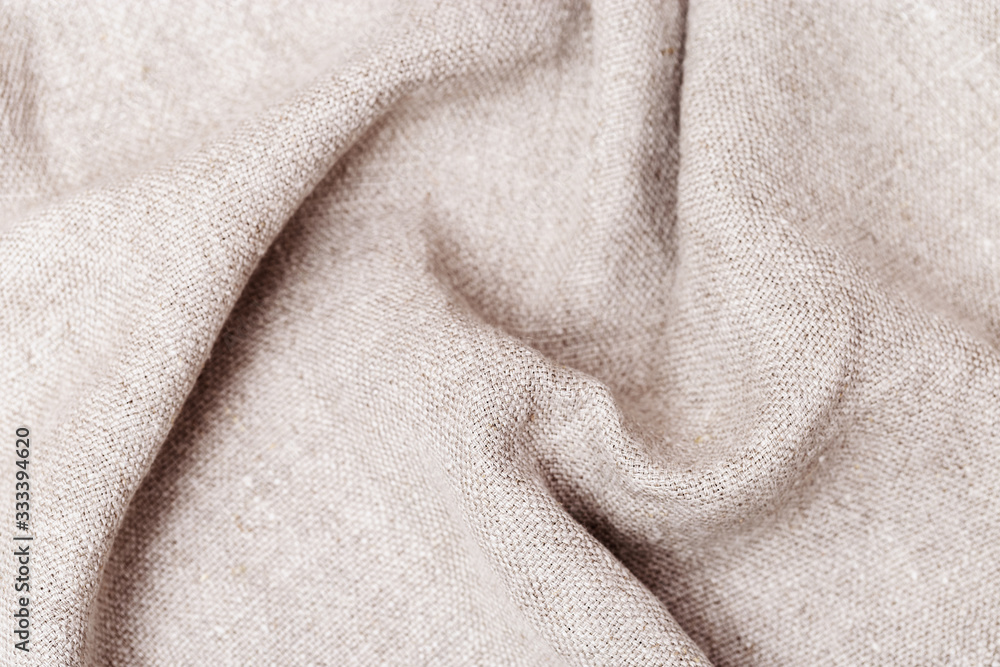 Rough texture of linen cloth. Close-up. Canvas is made of natural ingredients. Cotton beige fabric. Rough texture of linen cloth. Close-up. Canvas is made of natural ingredients. Cotton beige fabric.