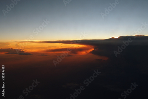  mysterious sunset with clouds from the airplane window with