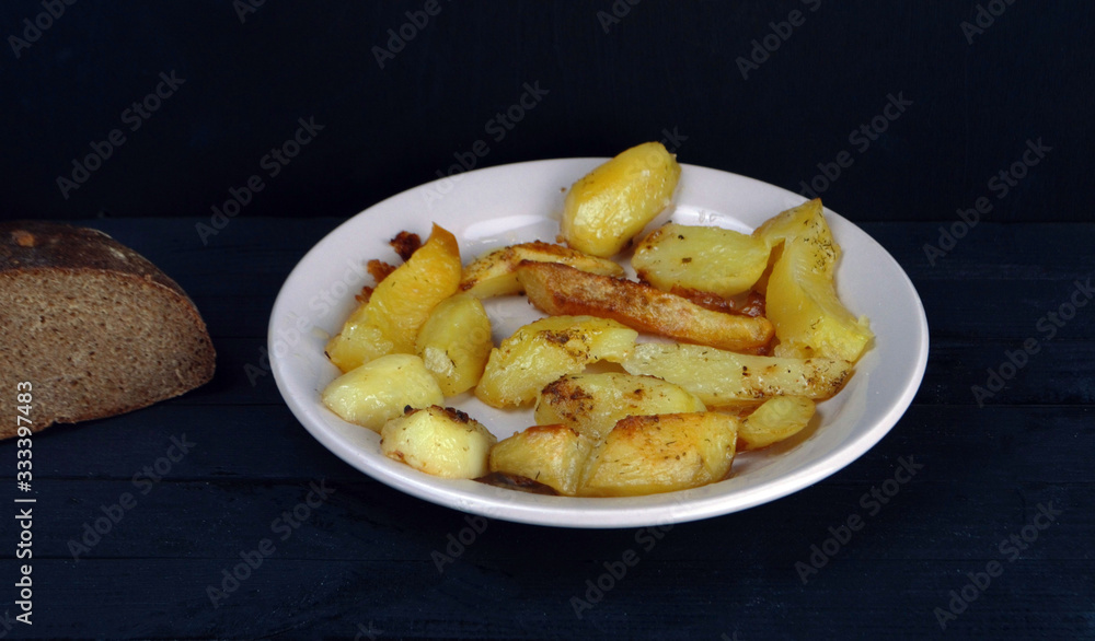 a plate of fried fresh potatoes is on the table a plate of fried fresh potatoes is on the table