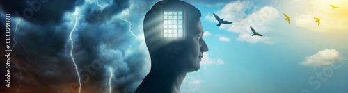 Silhouette of a man on the background of the prison bars, the sky and birds flying away as a symbol of freedom. Concept on the topic of psychology, psychiatry, religion, freedom