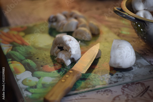Mushroom and knife on a cutting board in the kitchen