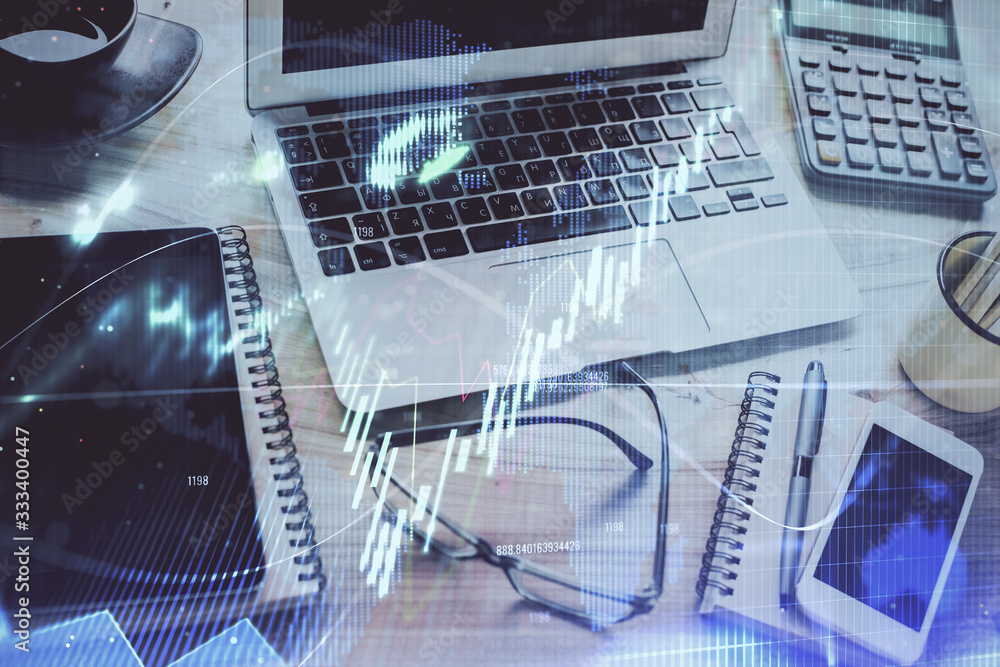 Forex market chart hologram and personal computer background. Double exposure. Concept of investment. Forex market chart hologram and personal computer background. Double exposure. Concept of investment.