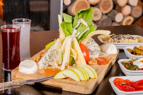 cheese plate next to it raki or wine photo