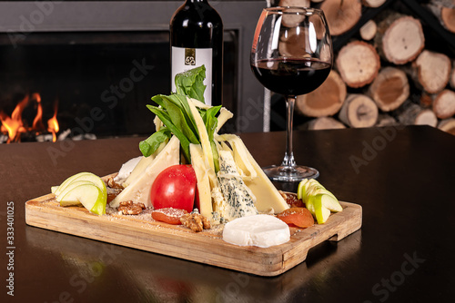 cheese plate next to it raki or wine photo