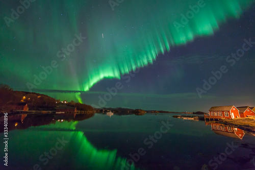 ULSTEINVIK, NORWAY - 2016 MARCH 06. Northern lights - Aurora borealis over harbor of Dimna.