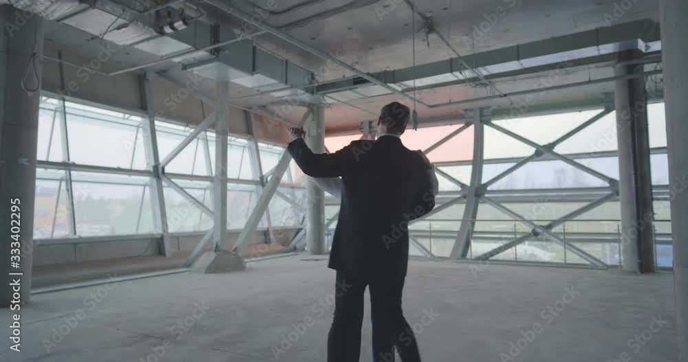 Happy couple dancing in rented commercial space celebrating success Happy couple dancing in rented commercial space celebrating success