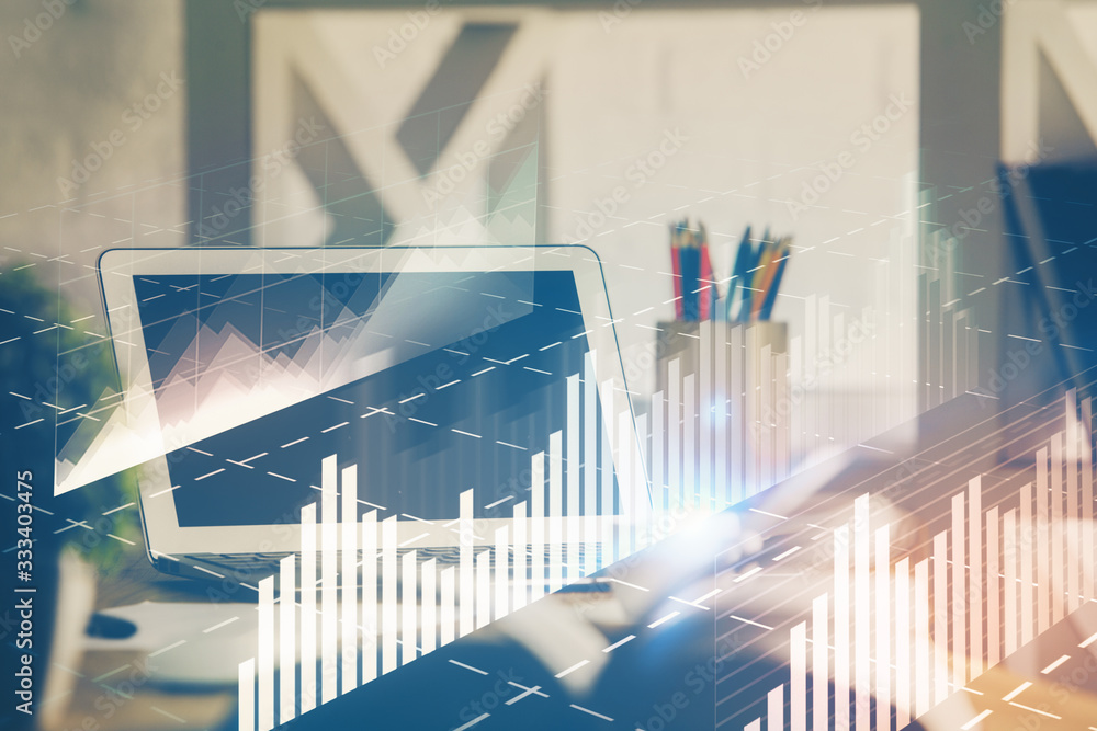 Stock market chart hologram drawn on personal computer background. Multi exposure. Concept of investment. Stock market chart hologram drawn on personal computer background. Multi exposure. Concept of investment.