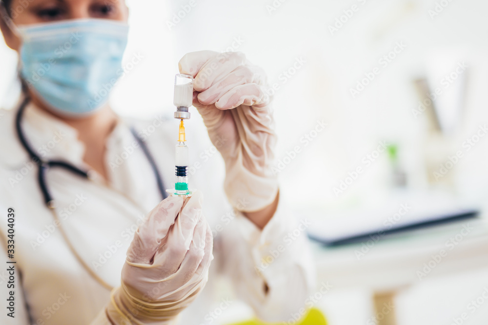 Doctor holding vaccine and syringe injection. It use for prevention,immunization. Doctor holding vaccine and syringe injection. It use for prevention,immunization.