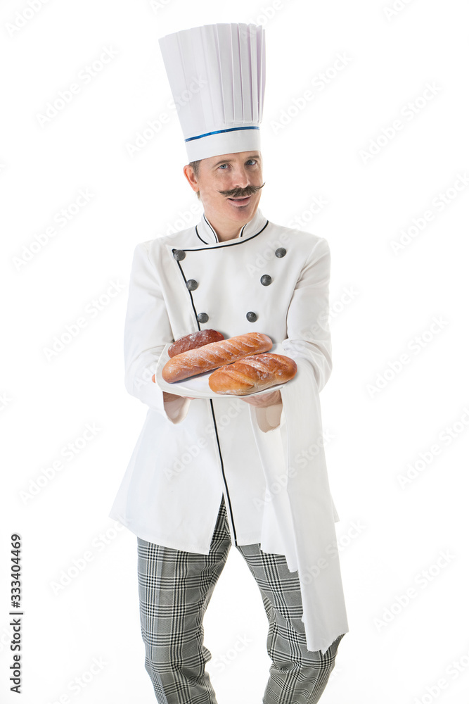 Cook in white uniform holds a bread on a plate on a white background Cook in white uniform holds a bread on a plate on a white background