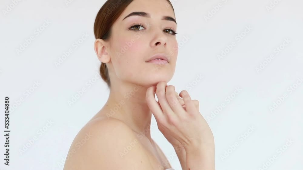 Slow motion of woman with beautiful face and perfect skin just cleaned