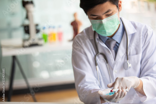 Wallpaper Mural Doctors are searching for Covid's anti-virus serum by studying lung infection photos, protected by a mask and sanitary gloves. Torontodigital.ca