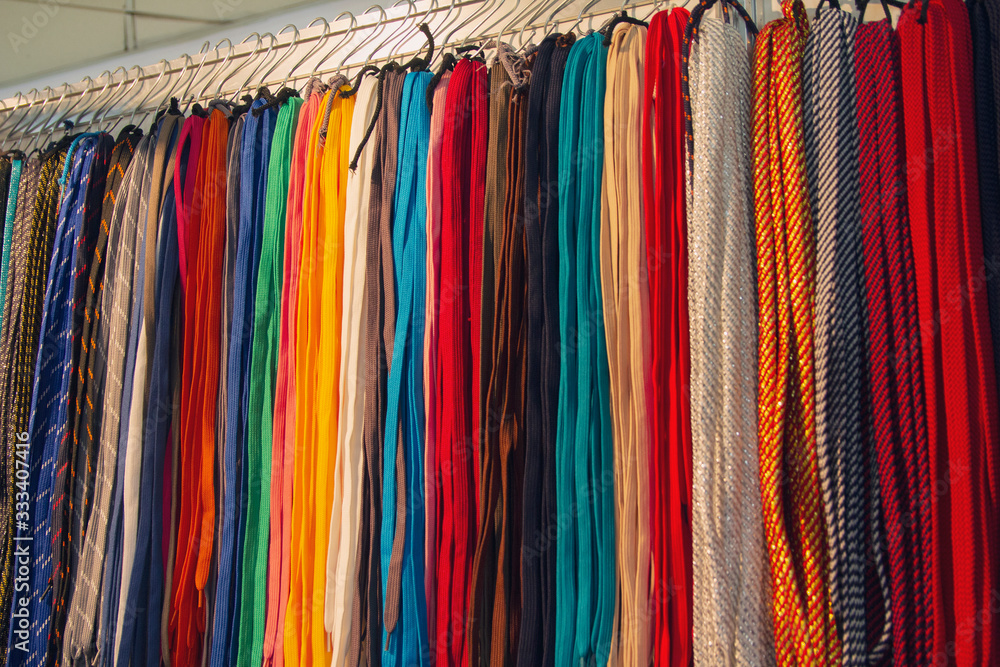 Many multi-colored laces in the storefront. Sale