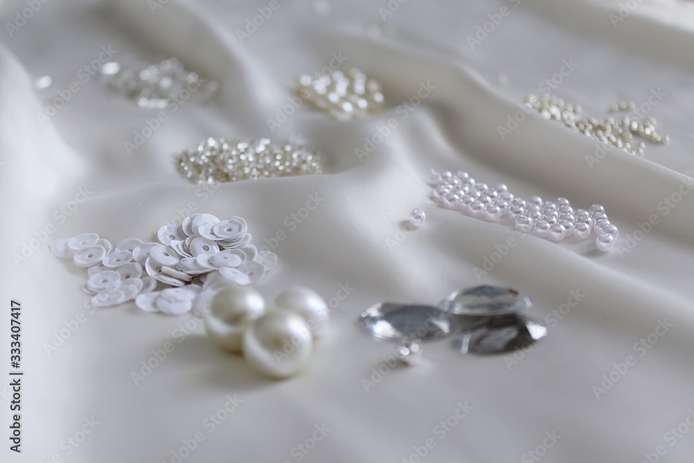 beads and paillettes on light fabric, scattered beads on silky fabric, scattered beads, handmade jewelry materials, beads close up, beads and paillettes on light fabric, scattered beads on silky fabric, scattered beads, handmade jewelry materials, beads close up,