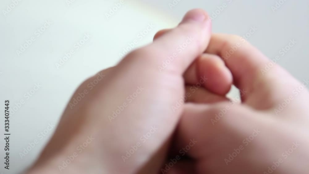 A young guy disinfects his hands with an antiseptic. Young guy sprays an antiseptic on his hands for prevention. Hands close up. A young guy disinfects his hands with an antiseptic. Young guy sprays an antiseptic on his hands for prevention. Hands close up.