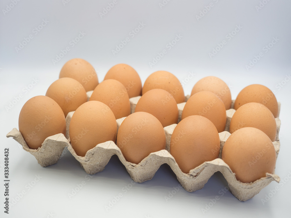 Fresh chicken eggs in a carton box ,cardboard package made of recycled waste paper on white background. Fresh chicken eggs in a carton box ,cardboard package made of recycled waste paper on white background.