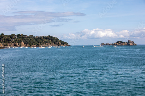  Fishing boats and yachts moored in the bay at high tide in Cancale, famous oysters production town. Brittany, France,