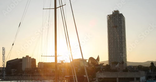 Sailboat and tower with sushine in port of barcelona photo