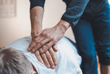 Physiotherapist treating patient for various physical ailments