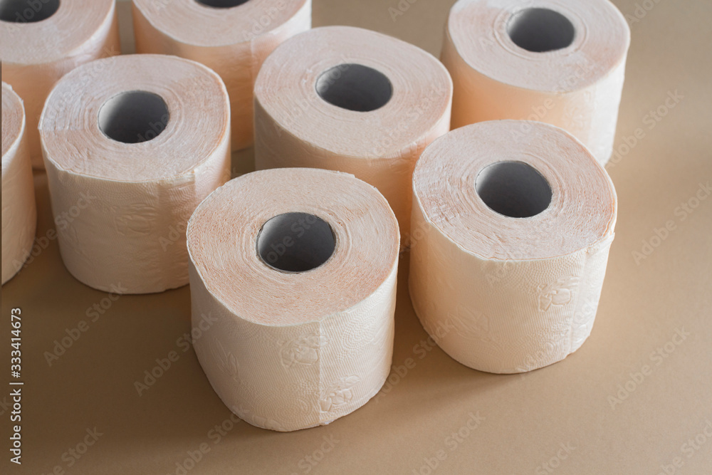 rolls of toilet paper peach beige color on beige background rolls of toilet paper peach beige color on beige background