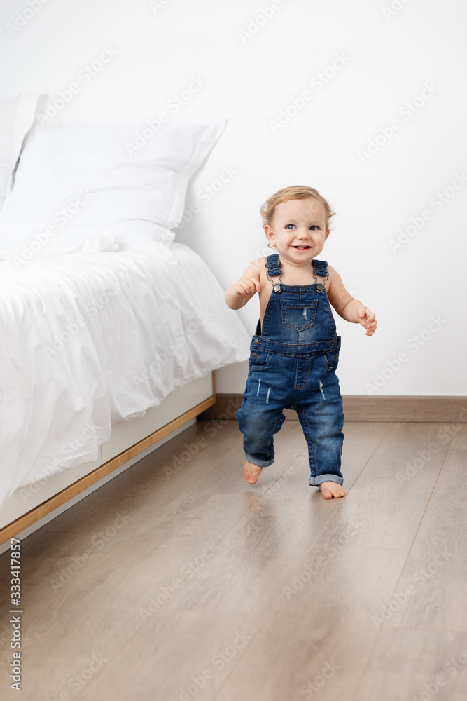 Happy baby making first steps in bedroom Happy baby making first steps in bedroom