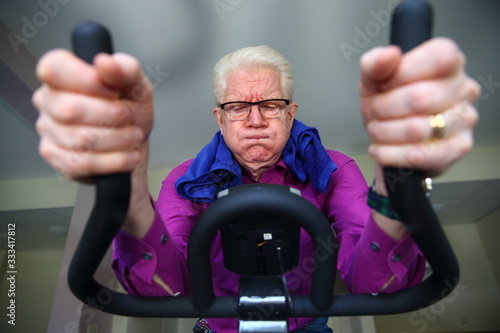 elderly man sweating while working out on a hometrainer