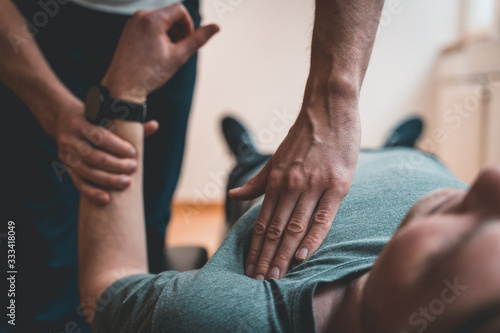 Physiotherapist treating patient for various physical ailments