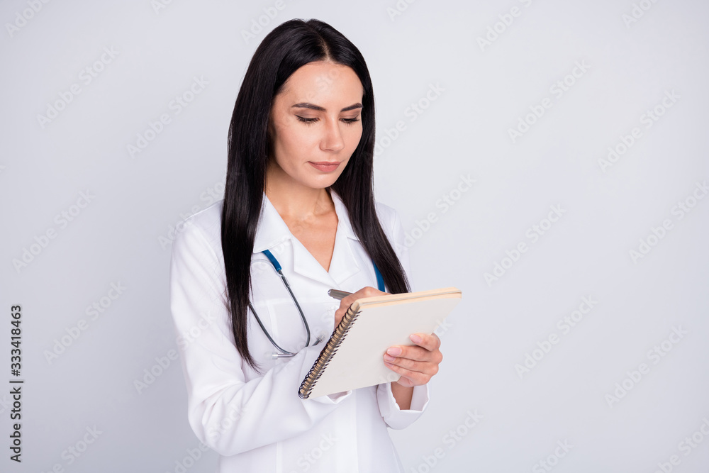 Photo of beautiful professional doc lady writing patient insurance medical prescription paper personal planner wear stethoscope white lab coat isolated grey color background