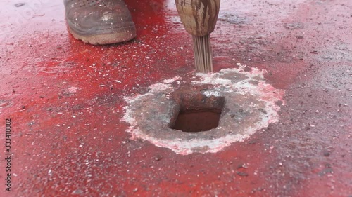 Process of derusting, paint and rust removal by pneumatic chisel from ship deck by vessel crew. Close up. photo