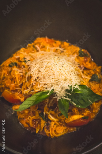 fetuccine spaghetti paste in tomato marinara sauce with tomatoes and grated cheese photo