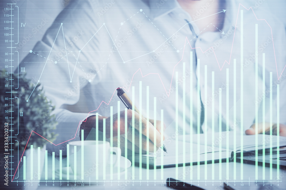 Double exposure of man's hands writing notes of stock market with forex chart. Double exposure of man's hands writing notes of stock market with forex chart.