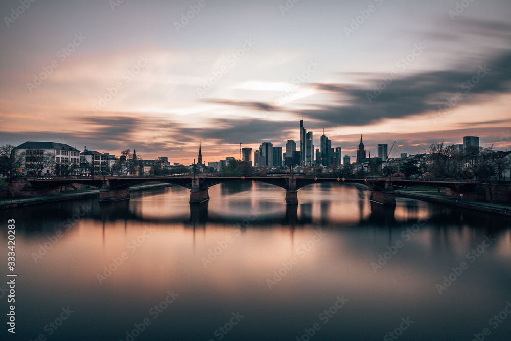 sunset over main river and Frankfurt skyline 