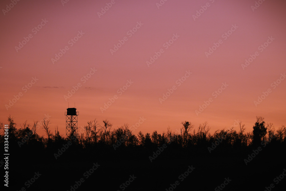 Silhouette of a Guard tower against the evening sky