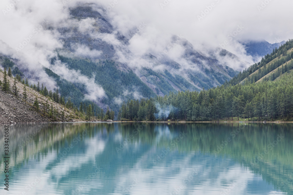 misty lake with blue water in the mountains