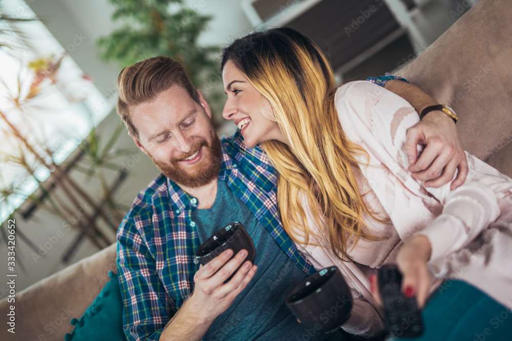 Obraz premium Couple in love sitting on the sofa, having fun.
