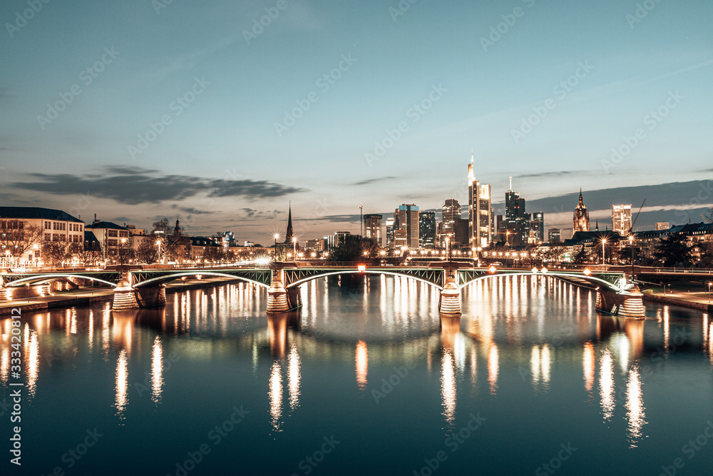 Fototapeta premium sunset over Frankfurt skyline, reflection in main river