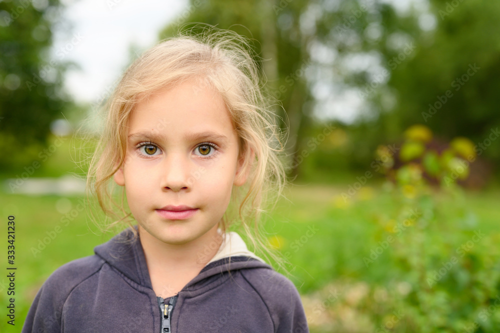 portrait of a cute little six year old european girl on the background of nature outdoor portrait of a cute little six year old european girl on the background of nature outdoor