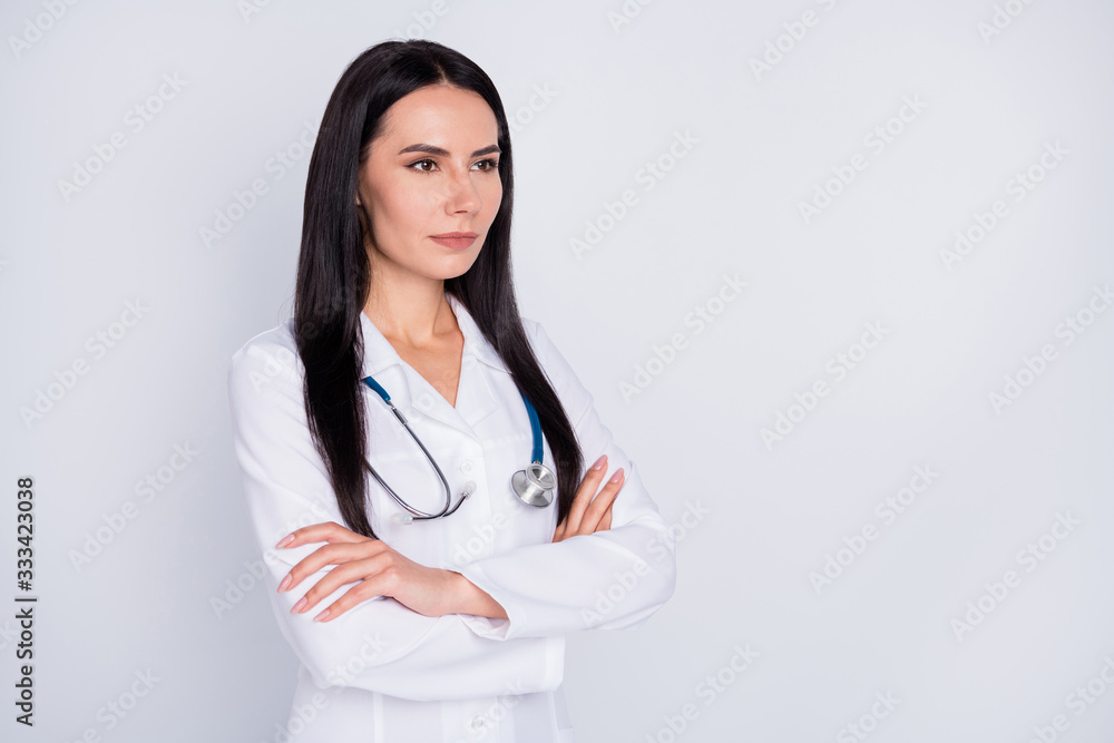 Photo of beautiful young doctor lady not smiling arms crossed experienced self-confident professional wear white lab coat stethoscope isolated grey color background