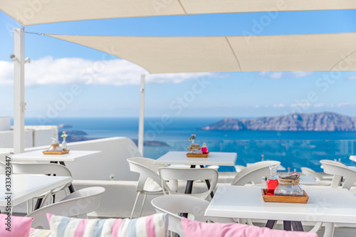 Greece, Santorini. Restaurant with served table in seafront of Aegean sea on Santorini Cyclades island with breathtaking, amazing and picturesque view in outdoor restaurant Oia. Summer vacation travel © icemanphotos