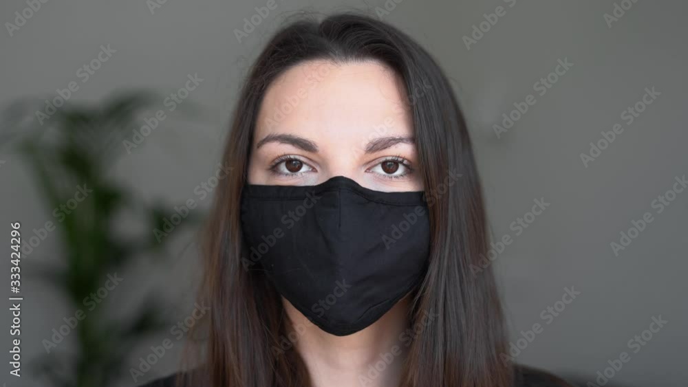 Young woman wearing black protective mask. Flu or virus pandemic. Allergy season Young woman wearing black protective mask. Flu or virus pandemic. Allergy season