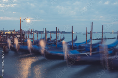 Empty, no tourists Venice. Gondolas moored by Saint Mark square with San Giorgio di Maggiore church in Venice, Italy