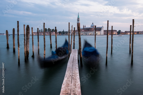 Empty, no tourists Venice. Gondolas moored by Saint Mark square with San Giorgio di Maggiore church in Venice, Italy