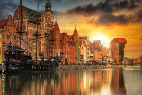 Beautiful old town with historical port crane in Gdansk over Motlawa river at sunset, Poland.