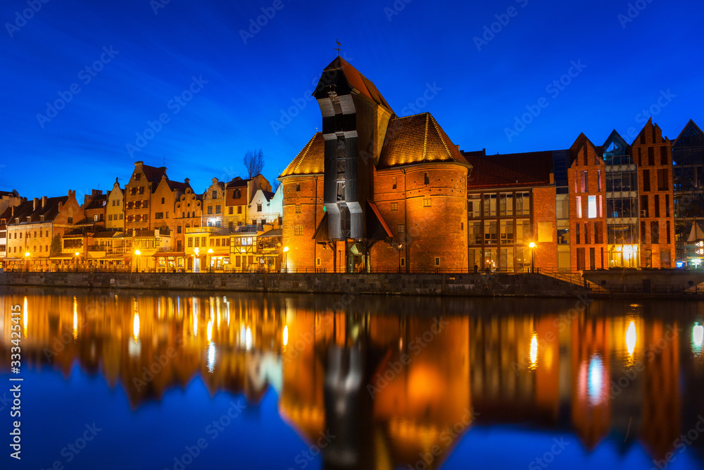 Old town in Gdansk with historical port crane over Motlawa river at night, Poland. Old town in Gdansk with historical port crane over Motlawa river at night, Poland.