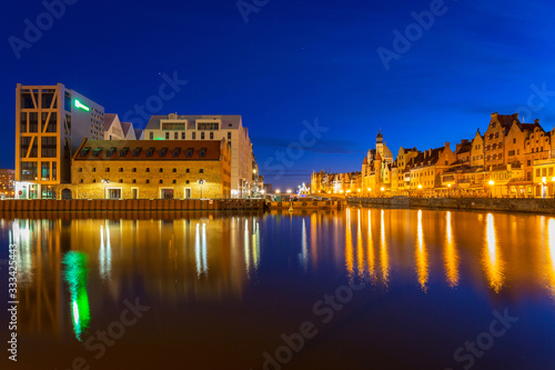 Old town in Gdansk with reflection in Motlawa river at night, Poland.