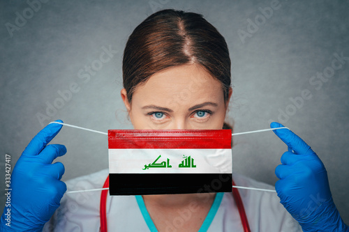 Coronavirus in Iraq Female Doctor Portrait hold protect Face surgical medical mask with Iraq National Flag. Illness, Virus Covid-19 in Iraq, concept photo