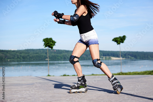 Photos Young woman, roller-blading on rollerdrome
